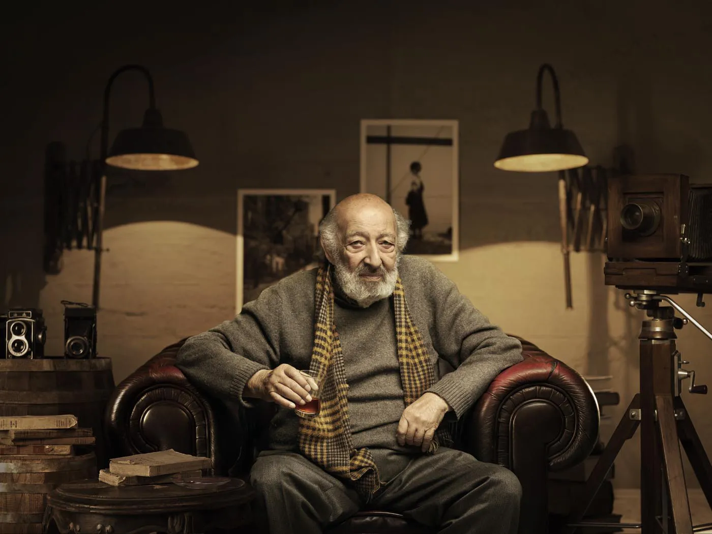 Portrait of an elderly photographer with a scarf in his studio by Mehmet Turgut